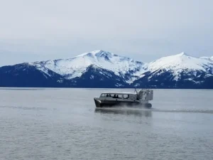 Allen Marine Explorer 24 on calm water below snowy peaks near Juneau
