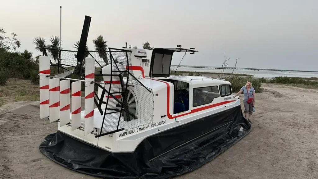 Angela Phillips beside an Amphibious Marine Explorer 24 hovercraft