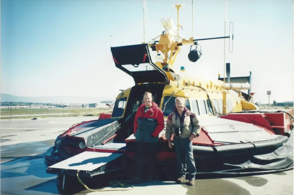 Bryan Phillips and Barry Palmer standing in front of a Canadian Coast Guard SR.N6 hovercraft