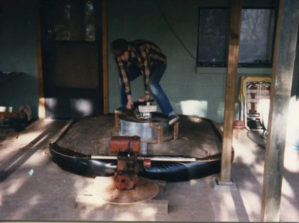 Bryan Phillips working on the Hover Platform, a small round hovercraft, in 1984