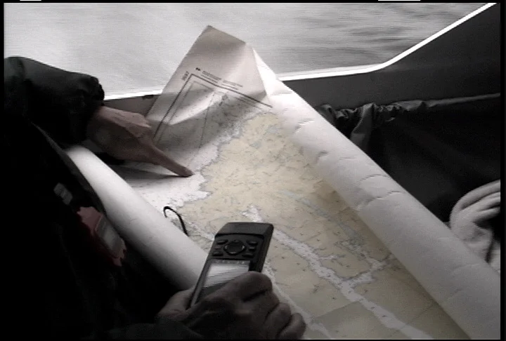 Barry Palmer pointing out Cape Caution on the chart inside the Explorer 20 cabin, 1998