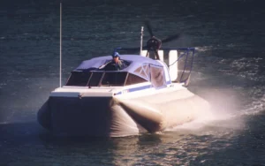 The Explorer 20 hovercraft running at speed on calm water