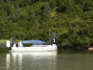 The Explorer 20 hovercraft on the Taku River below forested hills, 1998