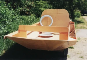 The Explorer 20 prototype hull under construction outdoors, 1995