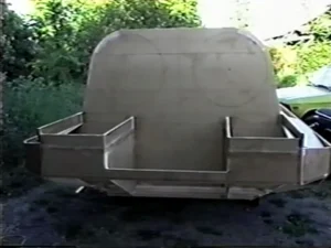 Bryan Phillips beside the Explorer 20 prototype hull on its wheeled cradle, May 1995