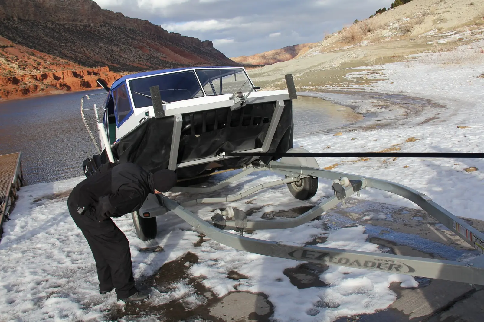 Securing an Explorer 22 to its trailer on the snow