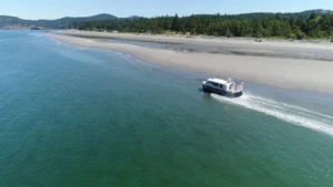 Aerial view of an Explorer 24 running beside a beach