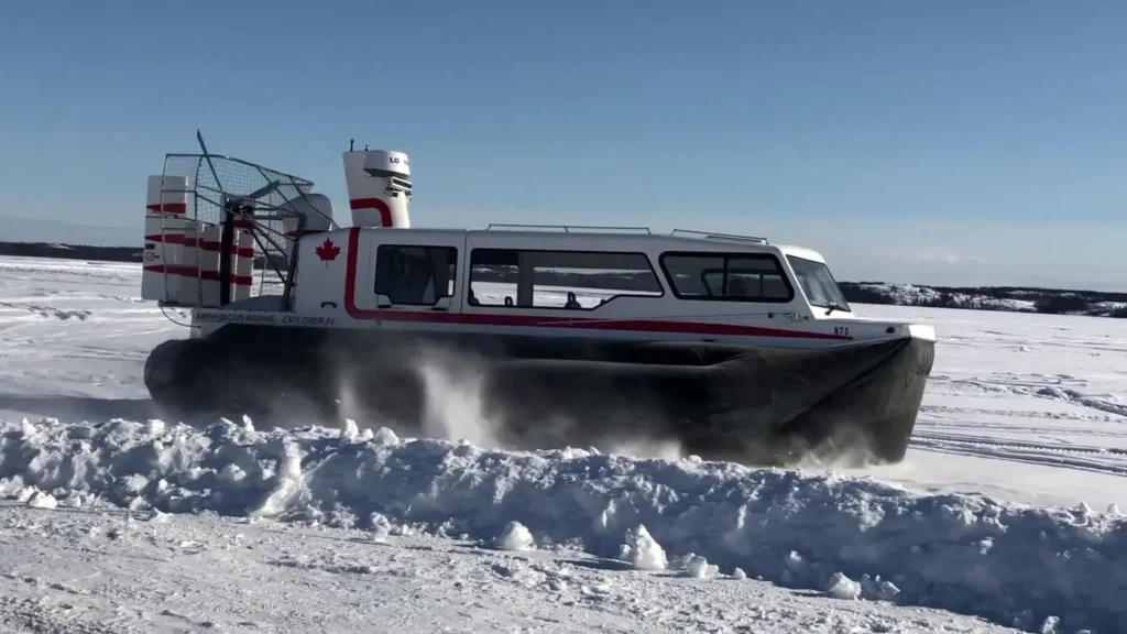 Explorer 24 with Canadian flags running through snow
