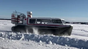 Explorer 24 with Canadian flags running through snow