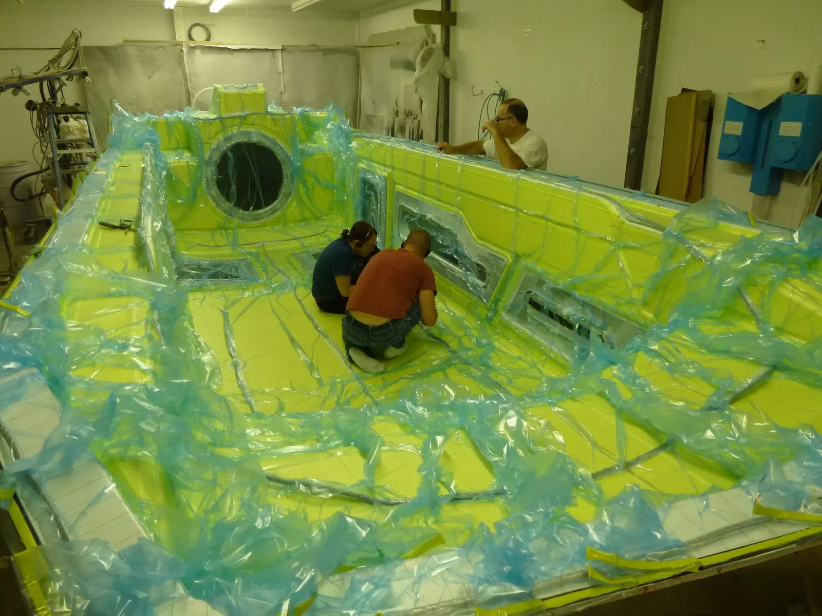 Angela and Jay preparing an Explorer 24 deck mold for vacuum infusion
