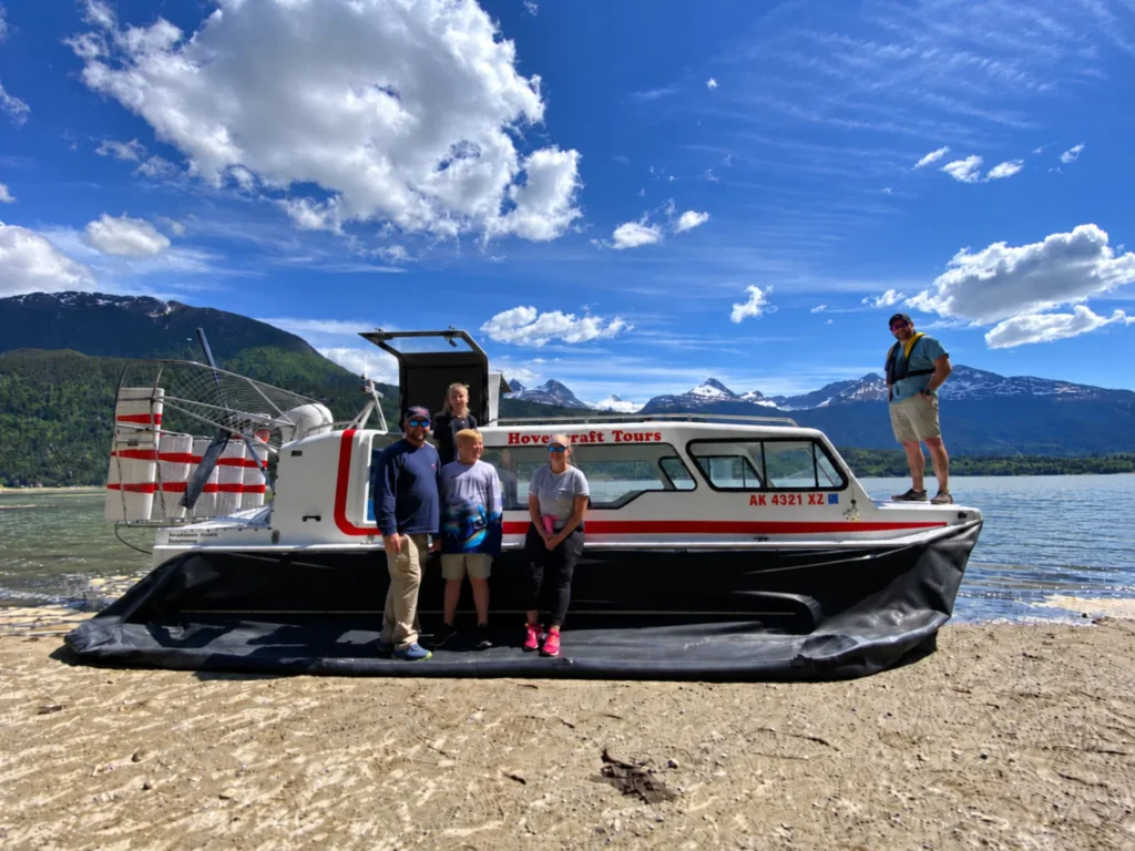 Tour passengers with an Explorer 24 hovercraft on an Alaska beach