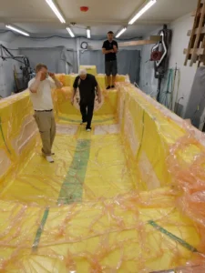 Builders inside the Explorer 24 hull mold