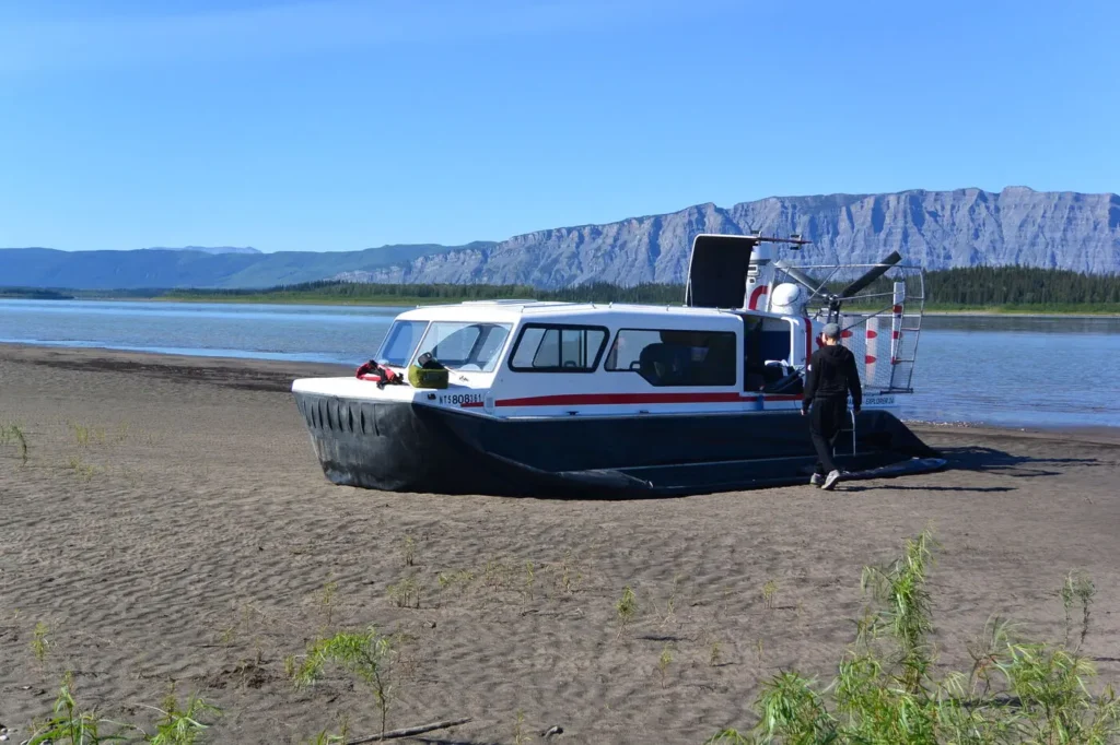 Paul's Explorer 24 on a sandy beach below a long ridge on the Mackenzie River
