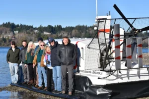 Bryan Phillips and a group of crew and guests standing on the skirt of an Explorer 24