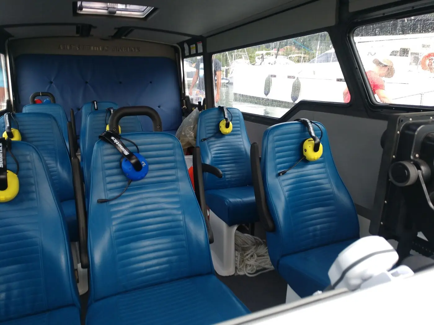 Blue passenger seats inside the Explorer 24 cabin, looking aft