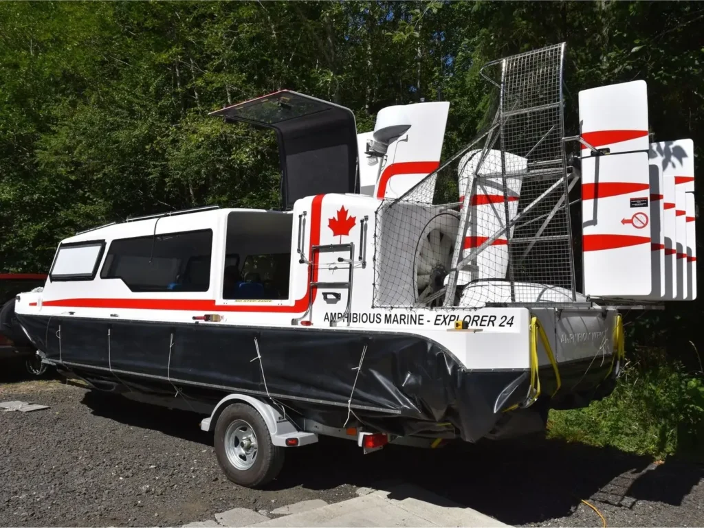 Paul's Explorer 24 on its trailer with Canadian flags on the rudders