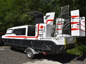 Paul's Explorer 24 on its trailer with Canadian flags on the rudders