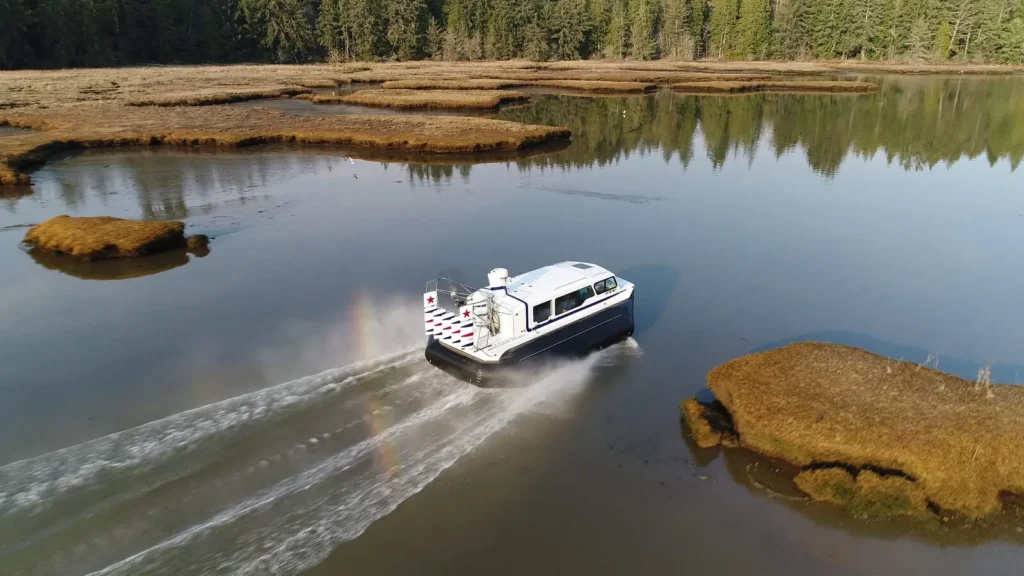 Aerial view of an Explorer 24 hovercraft crossing a marsh channel in Portland, Maine