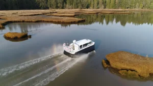 Aerial view of an Explorer 24 crossing a marsh channel in Portland, Maine