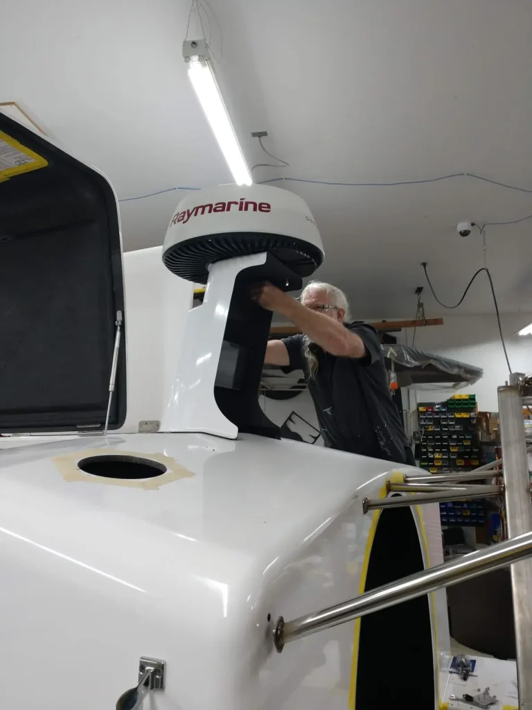 A builder fitting a Raymarine radar to an Explorer 24 cabin top