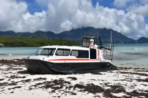Explorer 24 on a Seychelles beach with mountains behind