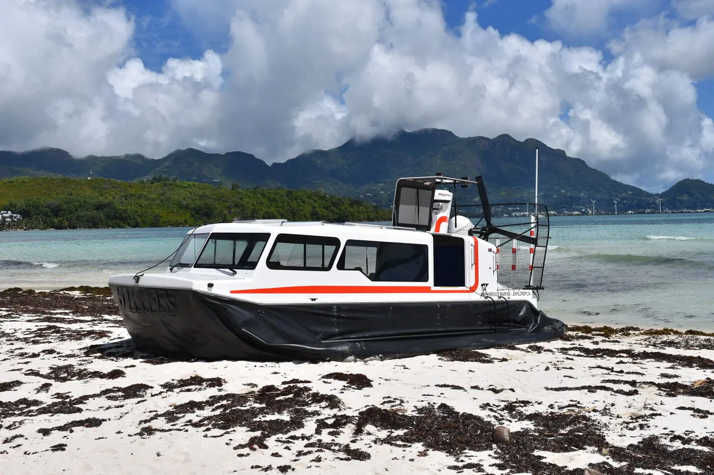 Explorer 24 on a Seychelles beach with mountains behind