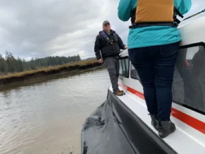 Crew walking the side deck of an Explorer 24