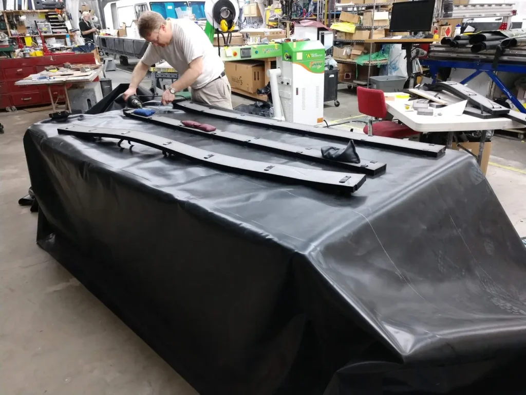 Builder fitting a skirt onto an Explorer 24 hull in the shop