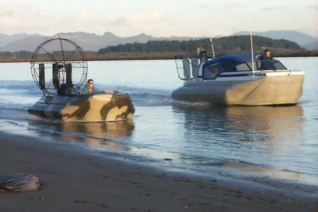 An Explorer and a Vanguard hovercraft running side by side near Fidalgo Island