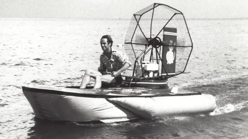 Black and white photo of a home built Fantastic 1 hovercraft on the water