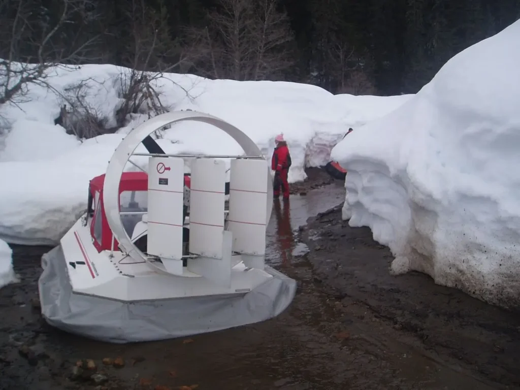 Kit built hovercraft parked beside deep snow banks