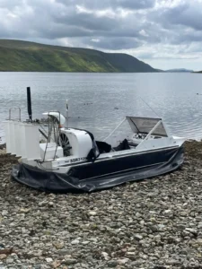 Mark's Explorer 22 on the shore with its canopy open