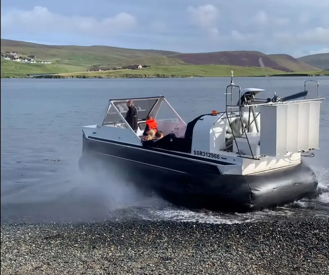 Mark's Explorer 22 running off a shingle beach in Shetland, throwing spray