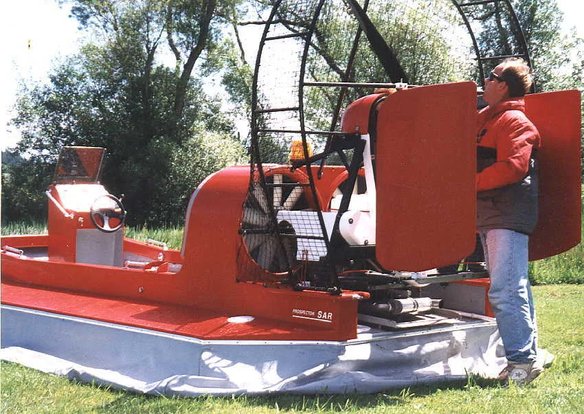 Crew member beside the thrust fan and rudders of the Prospector rescue hovercraft