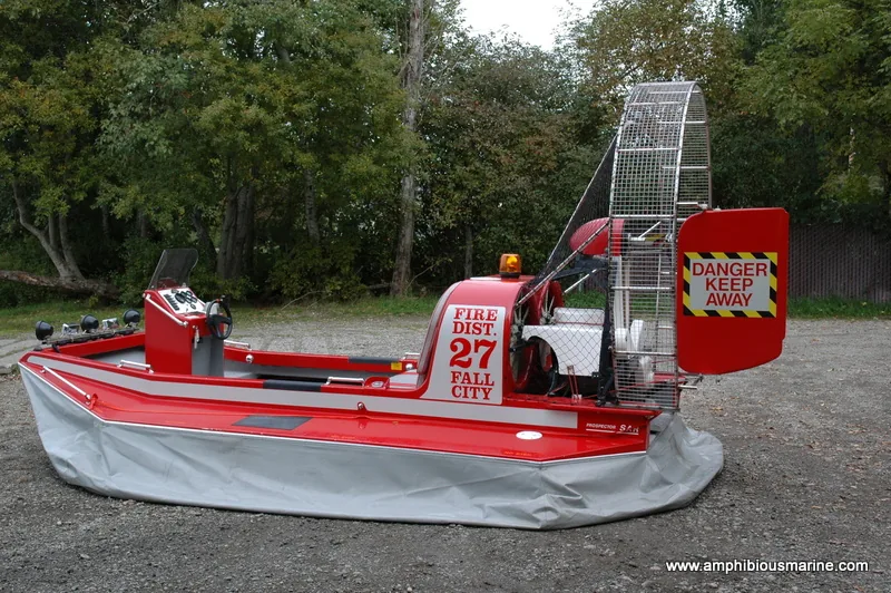 Red Prospector search and rescue hovercraft marked Fire District 27 Fall City, parked on gravel