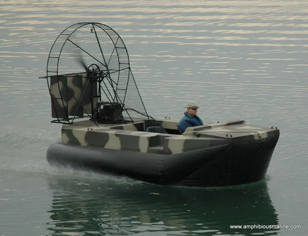 Camouflaged Super Surveyor hovercraft built for a duck hunting client, on the water