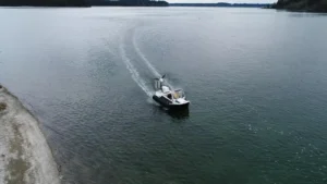 Surveyor 16 hovercraft leaving a beach onto calm water