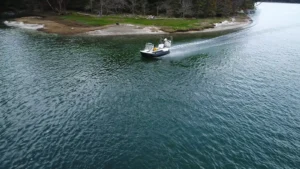 Surveyor 16 hovercraft running across open water near a sandy point