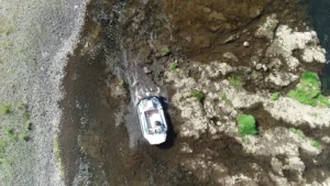 Surveyor 16 hovercraft passing over rocky shallows, seen from above