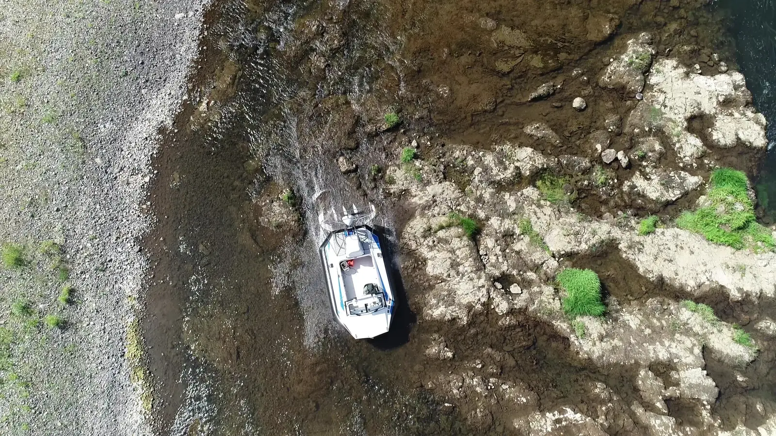 Surveyor 16 hovercraft passing over rocky shallows, seen from above