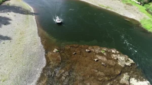Surveyor 16 hovercraft on a river bend above a rocky shallow