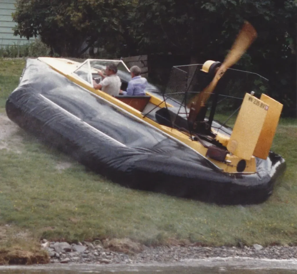 The yellow Sevtec hovercraft climbing a grassy hill, 1985